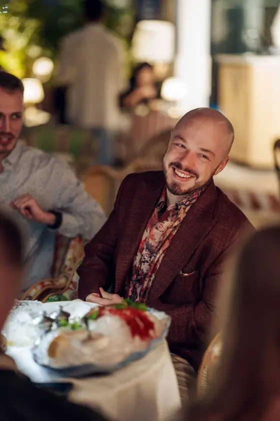 Dylan Madden smiling at a dinner table
